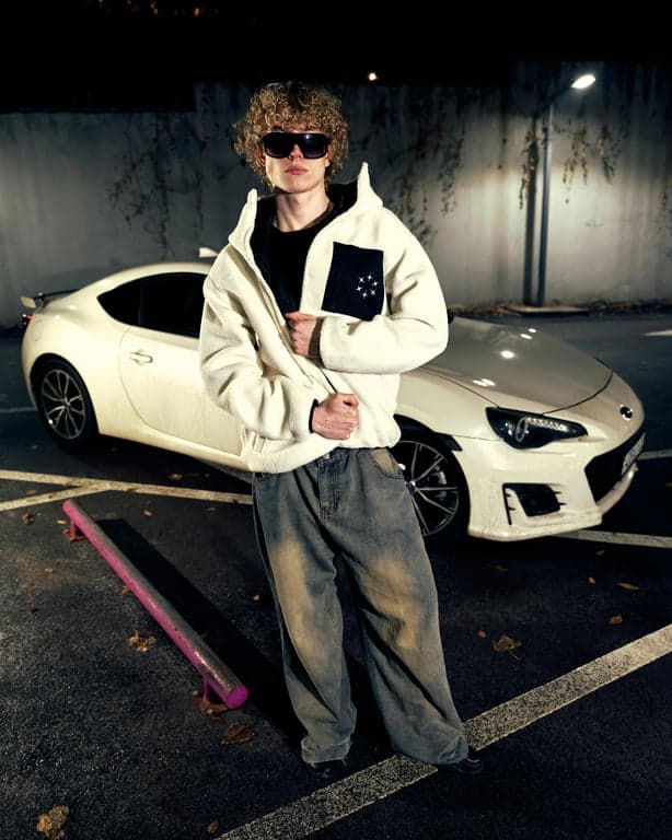 a portrait of a man edited in a Korean medium-length men hairstyle style, so that the hair is straight and medium length all around the head, slightly covering the forehead and ears in a common Korean men haircut silhouette, with no sharp length contrast, no curls or waves, and unchanged face and original lighting