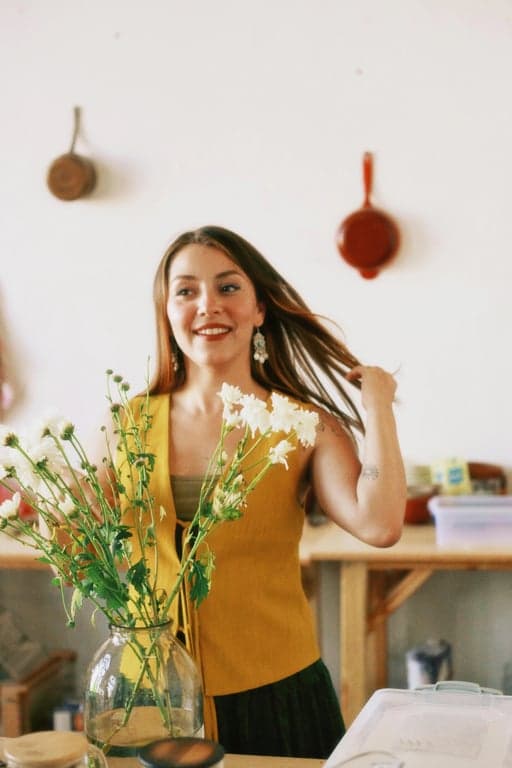 a portrait of a person edited in a shoujo anime style, featuring smooth rounded face shape, expressive sparkling eyes, softened jawline, natural lip color, and a calm gentle facial expression
