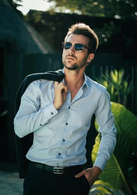 A professional portrait of a man transformed with cinematic teal and orange tones, high contrast between cool shadows and warm light, dramatic posing, studio quality.