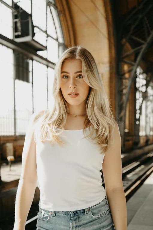 Generate lightweight air bangs with a semi-transparent, wispy appearance, leaving subtle gaps between strands. Adjust thickness and spacing based on forehead width and hairline shape, ensuring the bangs look airy, natural, and softly layered rather than heavy or pasted on.