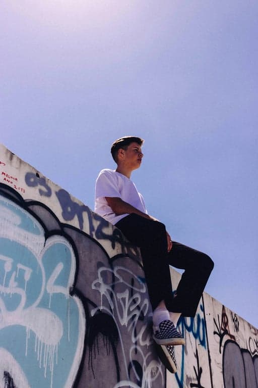 a portrait of a person edited to resemble an aged photograph taken with an old camera, emphasizing film grain and color shift