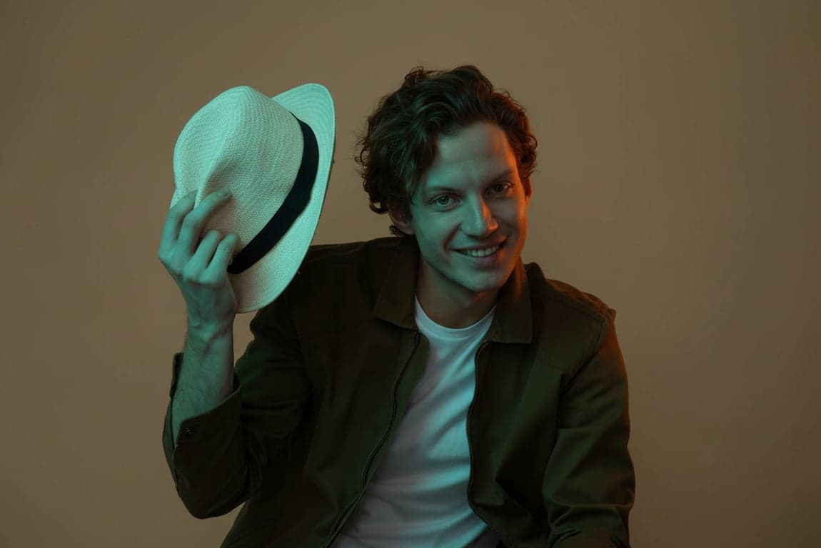 a portrait of a man, strong teal shadows and warm orange highlights, cinematic lighting, sharp focus, moody atmosphere.