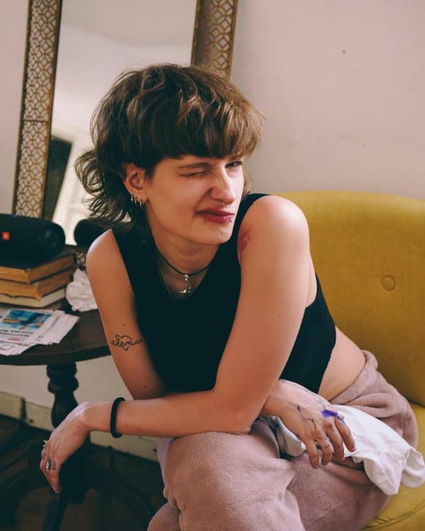 anime tattoo before photo - woman sitting on the sofa