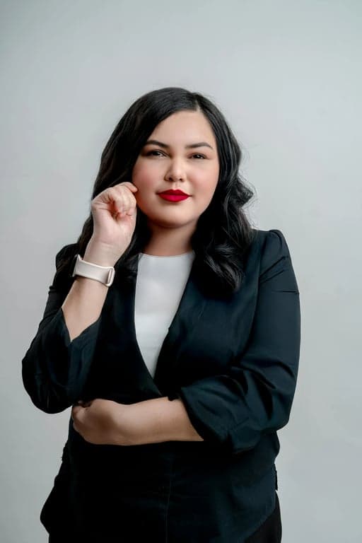 a portrait of a person edited to transform a square face into a narrower and longer face shape by strongly reducing jaw width, removing sharp jaw angles, compressing the face horizontally, and creating a slimmer lower face silhouette while keeping all facial features unchanged