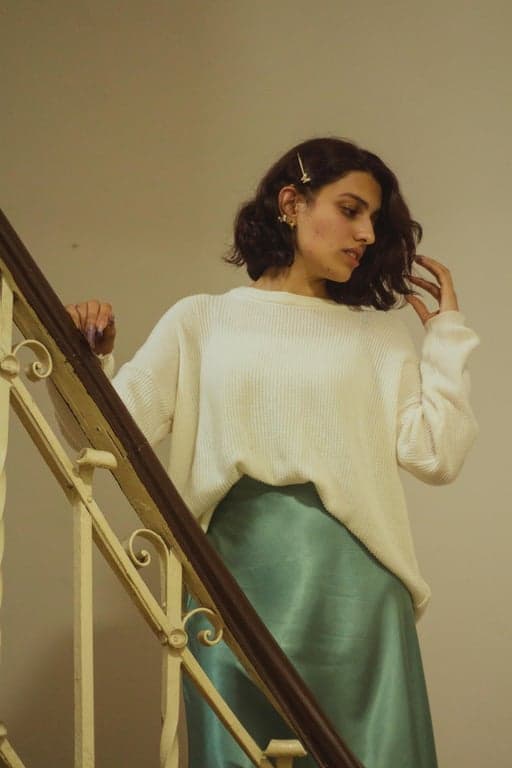 a portrait of a person transformed into an American Gothic art style featuring rigid upright posture, symmetrical frontal composition, serious restrained facial expression, simplified realistic facial structure, muted earthy color palette, flat controlled lighting, sharp edges, and a quiet tense American rural realism atmosphere