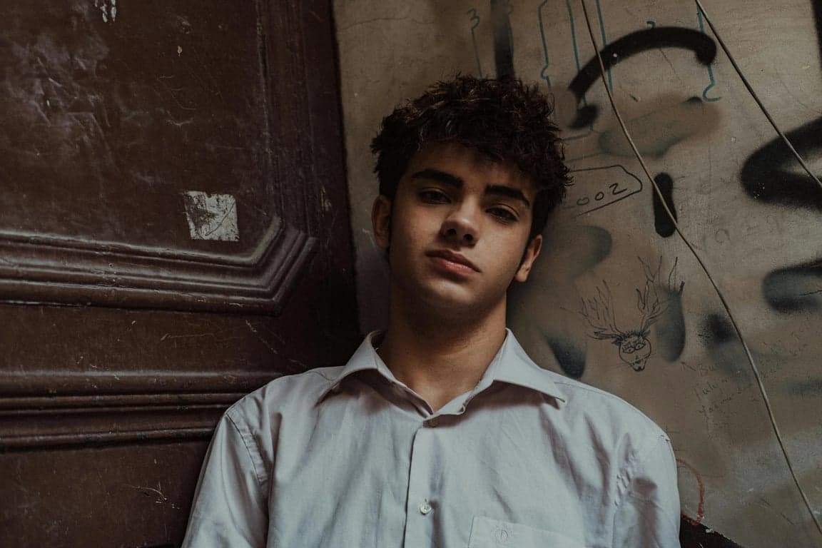 a portrait of a man, comic strip selfie, panel border, thought bubble with \"Wah!\", classic peanuts font, yellow tint.