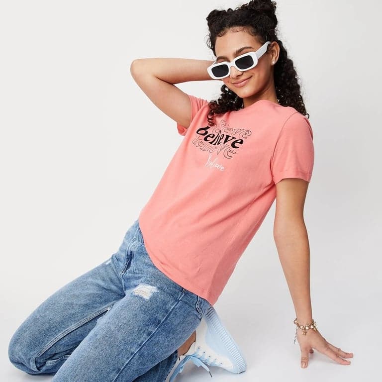 a portrait of a woman with mod makeup and haircut, high-contrast black and white with a pop of color, geometric background, dramatic eye makeup.