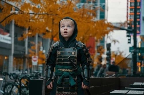 Kids ninja after – child wearing a samurai-ninja hybrid costume with ornate details