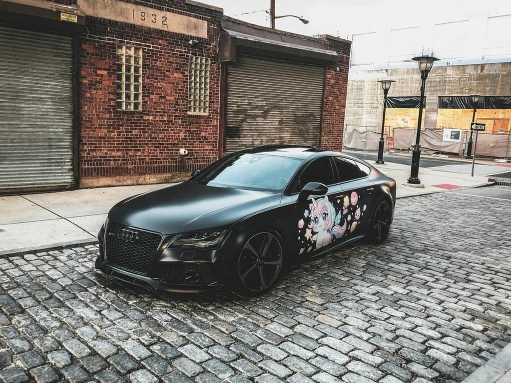 AI anime car sticker after photo - black car on the street with car sticker